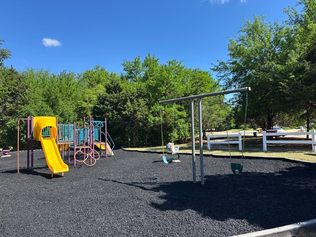School playground surfaced with black rubber mulch