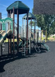 Town of Taloga playground slide on unpainted black rubber mulch